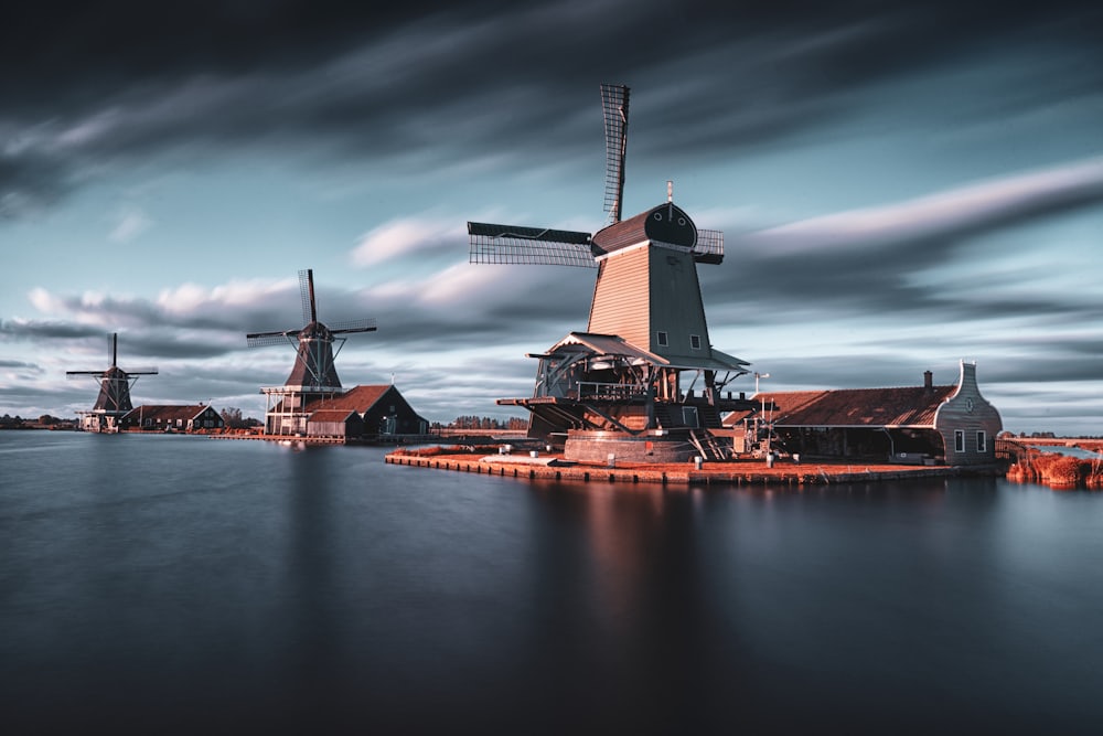 Three windmills beside a Dutch lake