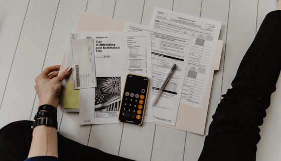 Business owner checking accounts with a calculator