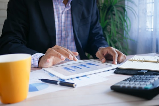Finance professional reviewing figures on a tablet