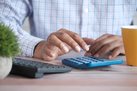 Desk with calculator and paperwork